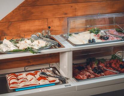 Breakfast buffet at Hotel Villa Alberta with platters of cheese and cold cuts.